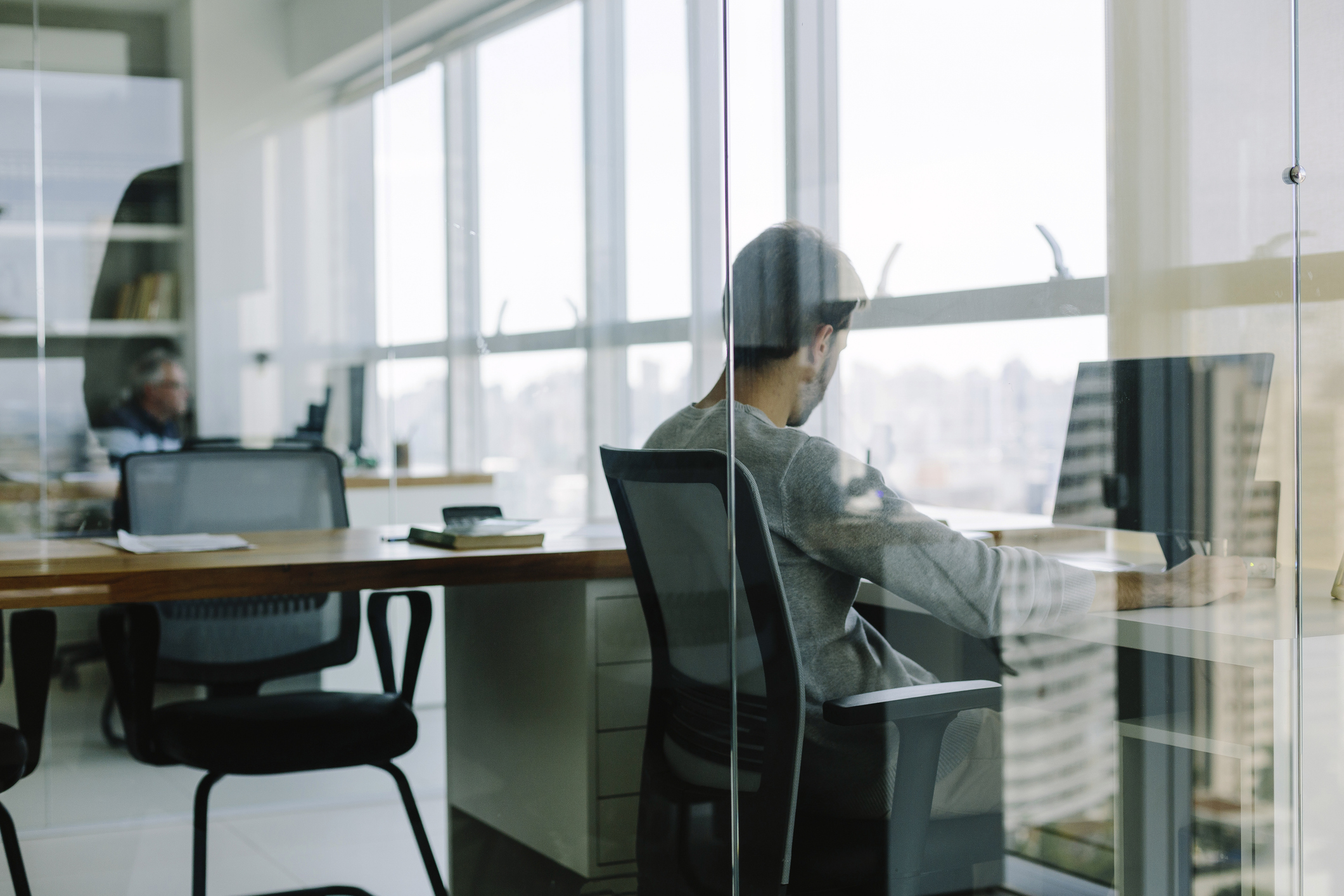 Man sitting at his desk in front of his computer, place work.